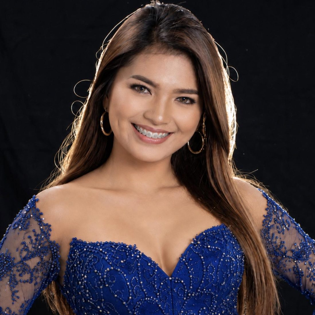 OM in her blue gown, smiling